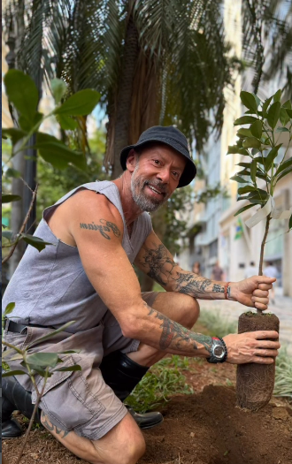 Eduardo Paziam plantando muda em canteiro urbano